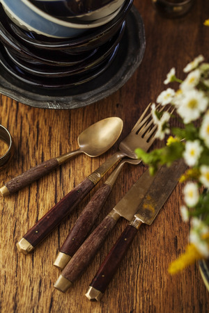 Vintage tableware, cutlery on dark brown wooden backroundの写真素材