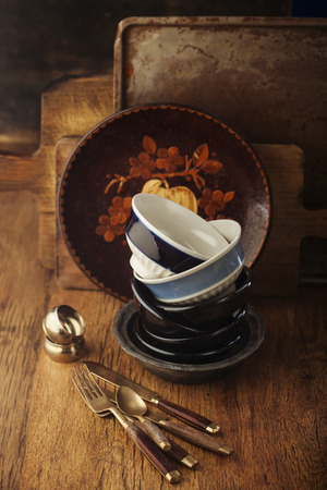 Vintage tableware, cutlery on dark brown wooden backroundの写真素材