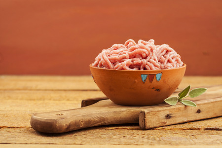 Raw red mince in bowl on wooden backgroundの写真素材