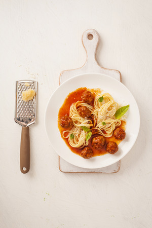 Pasta with meatballs and basil with tomato sauceの写真素材