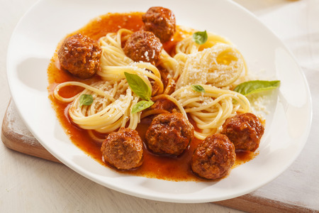 Pasta with meatballs and basil with tomato sauceの写真素材