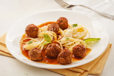 Pasta with meatballs and basil with tomato sauceの写真素材
