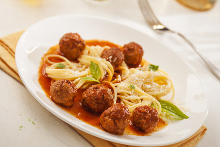 Pasta with meatballs and basil with tomato sauceの写真素材
