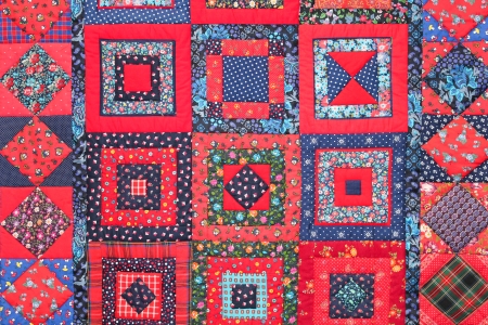 close up of  square fabrics pieced together into a quiltの写真素材