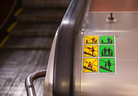 warning sign on escolator in subway station