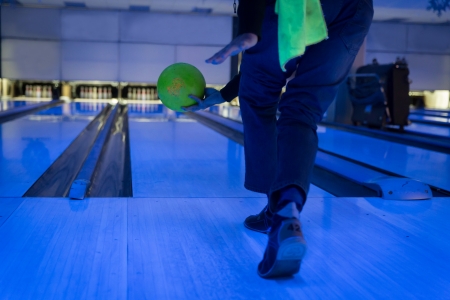 a man throwing a ball playing bowlingの写真素材