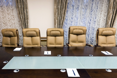 conference room with wooden table and beige leather armchairsのeditorial素材