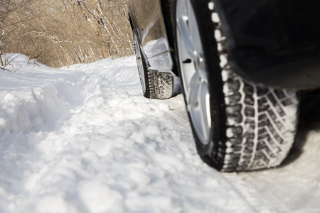 car driving in forest on the snowの写真素材