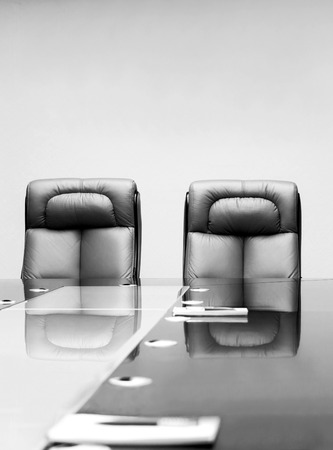 conference room with wooden table and beige leather armchairsの写真素材