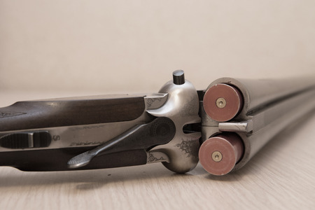A wooden retro shotgun with shotgun shellsの写真素材