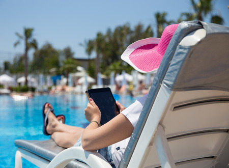 woman on sunbed waering beautiful pink hat