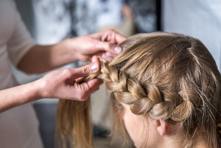 Hairdresser make braid in beauty salonの写真素材