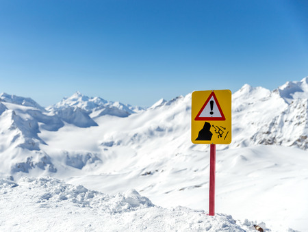 Warning sign in  beautiful mountain landscape. Sign warns about the risk of fallingの写真素材