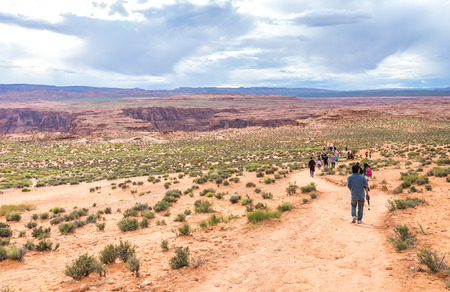 PAGE, ARIZONA - MAY 25: Hikers at Horseshoe Bend on May 25, 2015 in Page AZ,USA. Thousands of people from all over the world  visit this unique place every year.のeditorial素材