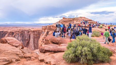 PAGE, ARIZONA - MAY 25: Hikers at Horseshoe Bend on May 25, 2015 in Page AZ,USA. Thousands of people from all over the world  visit this unique place every year.のeditorial素材