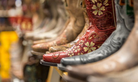 Close-up of new cowboy boots on shelf in a storeの写真素材