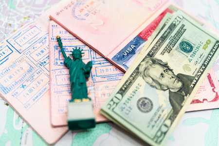 Passport, money and small statue of libertyの写真素材