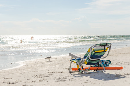 landscape of ocean and beach with chair and bagの写真素材