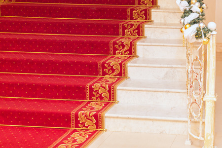 Classic red carpet on a marble staircaseの写真素材