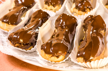 Mini vanilla eclairs with chocolate frosting