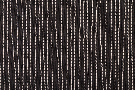 Black fabrick with white stitches background texture