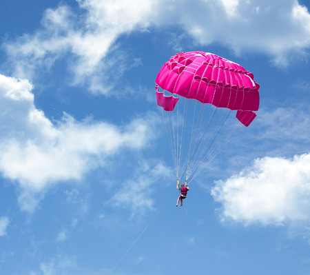 Parachuting over a sea, towing by a boatの写真素材