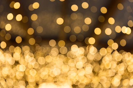 Golden abstract background with bokeh defocused lightsの写真素材