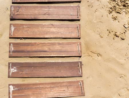 Wooden beach boardwalk, path with sand with copy spaceのeditorial素材