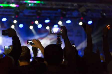 silhouettes of crowd at concert near stageの写真素材