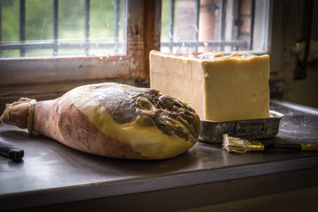 Greasing hams with lard before hanging them to dry in storageの写真素材