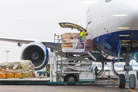 Loading cargo into the aircraft before departureのeditorial素材