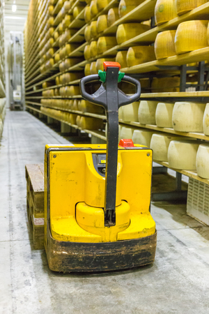 Parmigiano Cheese factory production shelves with aging cheese iの写真素材