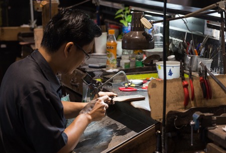 Thai Jeweler making fine Jewelry in a workshop