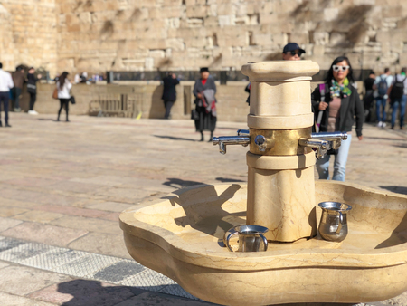 JERUSALEM, ISRAEL - JANUARY 22, 2019: Cranes with water and special ritual Cups for washing hands beside the Wailing Western Wall in Jerusalem Israel.のeditorial素材