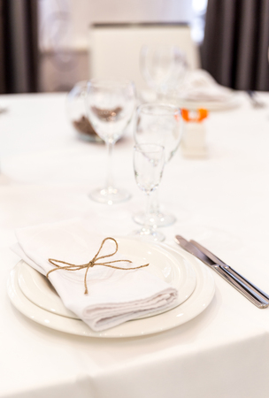 Plate, forks, napkin and knife in restaurantの写真素材