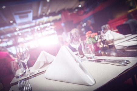 Restaurant table setting with bright light flareの写真素材