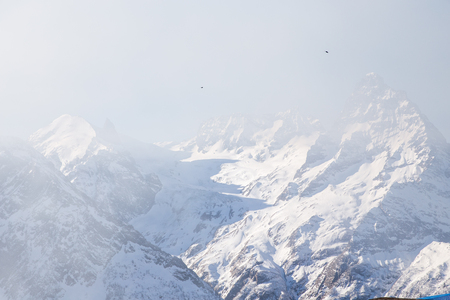 DOMBAI, RUSSIA - JANUARY 3, 2014: People are lifting on open lft high up in Caucasus mountainsのeditorial素材