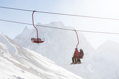 DOMBAI, RUSSIA - JANUARY 3, 2014: People are lifting on open lft high up in Caucasus mountainsのeditorial素材