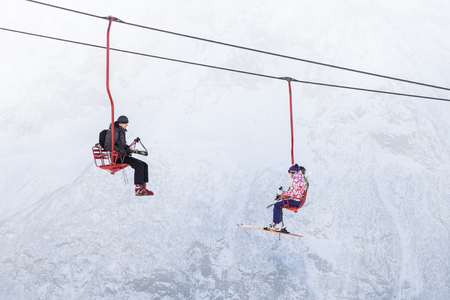 DOMBAI, RUSSIA - JANUARY 3, 2014: People are lifting on open lft high up in Caucasus mountainsのeditorial素材