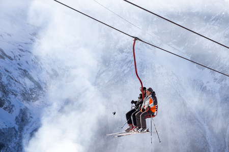 DOMBAI, RUSSIA - JANUARY 3, 2014: People are lifting on open lft high up in Caucasus mountainsのeditorial素材
