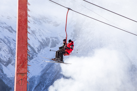 DOMBAI, RUSSIA - JANUARY 3, 2014: People are lifting on open lft high up in Caucasus mountainsのeditorial素材
