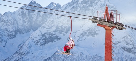 DOMBAI, RUSSIA - JANUARY 3, 2014: People are lifting on open lft high up in Caucasus mountainsのeditorial素材