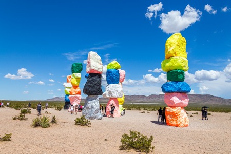LAS VEGAS, NEVADA, USA - 12 MAY, 2019: Seven Magic Mountains art installation near Las Vegas city. Pillars made of neon colored boulders stand against barren desert background and blue sky.のeditorial素材