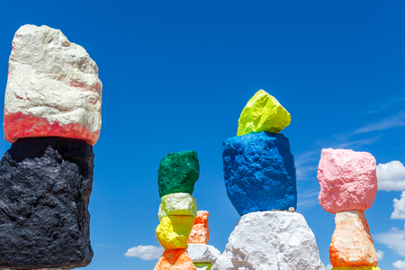 LAS VEGAS, NEVADA, USA - 12 MAY, 2019: Seven Magic Mountains art installation near Las Vegas city. Pillars made of neon colored boulders stand against barren desert background and blue sky.のeditorial素材