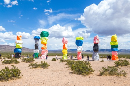 LAS VEGAS, NEVADA, USA - 12 MAY, 2019: Seven Magic Mountains art installation near Las Vegas city. Pillars made of neon colored boulders stand against barren desert background and blue sky.のeditorial素材