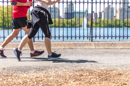 NEW YORK, USA - 15 MAY, 2019: Jogger running along Central Park reservoir in New York. Central Park...