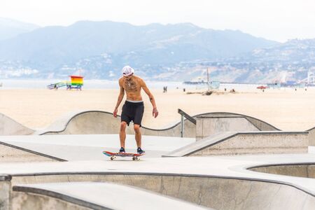LOS ANGELES, CALIFORNIA, USA - May 11, 2019: Concrete ramps and palm trees at the popular Venice...