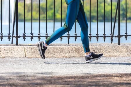 NEW YORK, USA - 15 MAY, 2019: Jogger running along Central Park reservoir in New York. Central Park is full of active people throughout the year.のeditorial素材