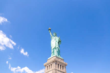 Close view of the Statue of Liberty over blue skyの写真素材