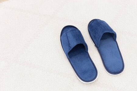 Blue man hotel slippers on carpet with copy spaceの写真素材
